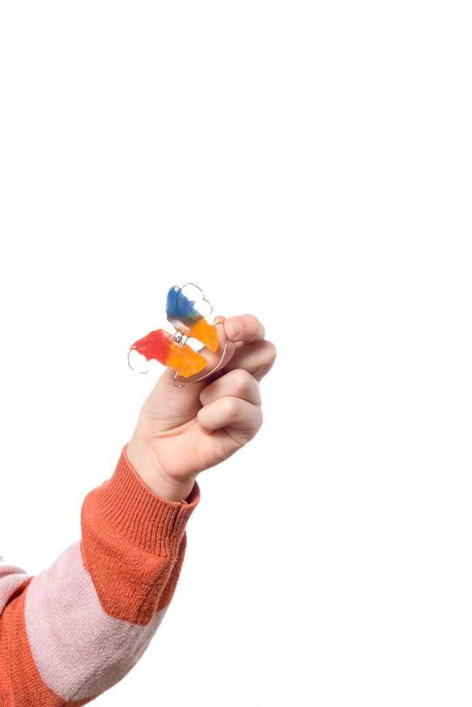 Child's hand with orthodontic appliance isolated on a white background
